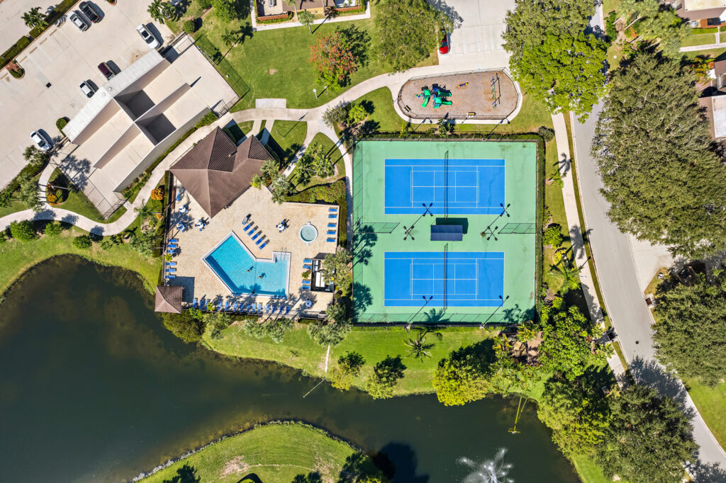 an aerial view of pool and tennis court