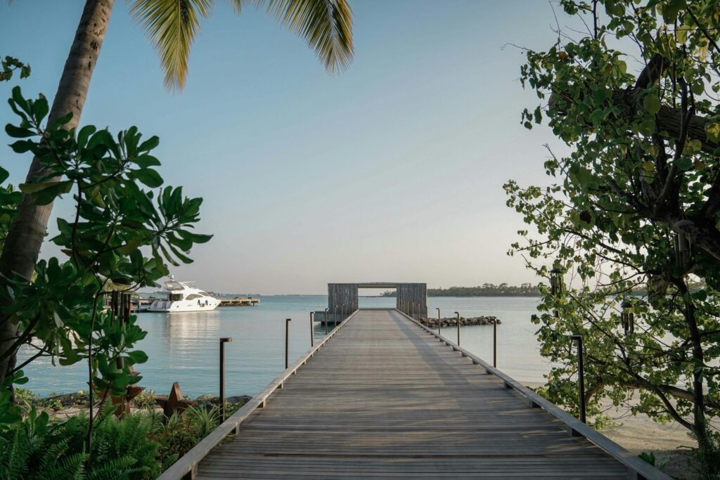 a long wooden dock in the beach