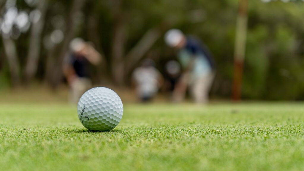 a golf ball on green grass field during daytime