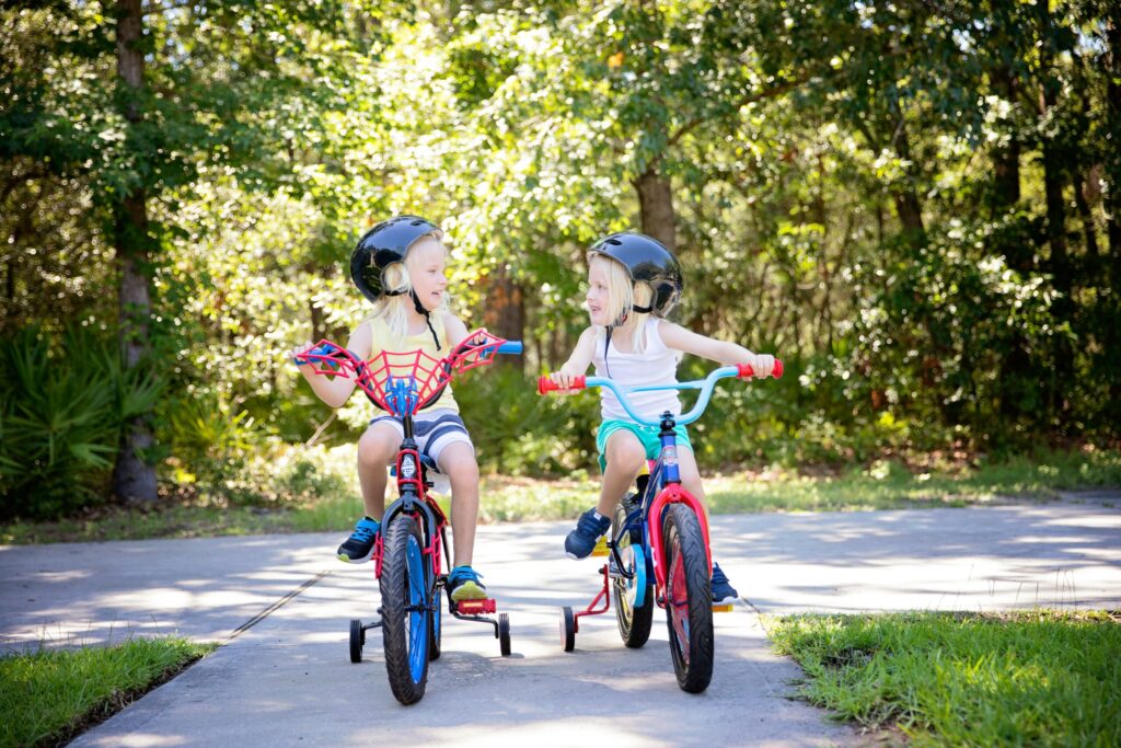 two girls riding a bicycle during daytime